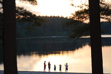 Family silhouetted on Fearing Pond campground