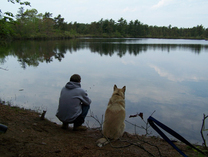 man & dog at pond